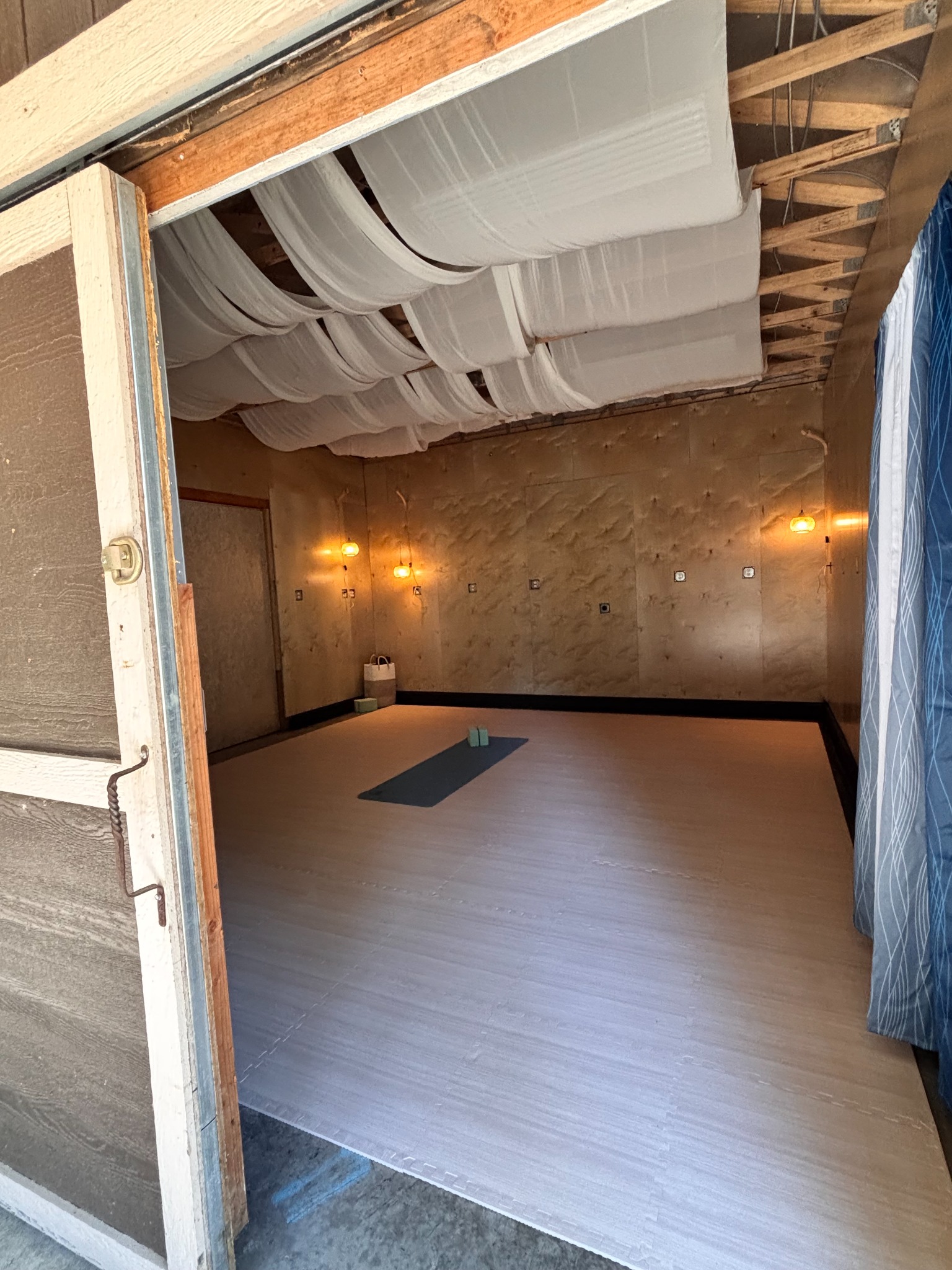 Open doorway showing the exterior and interior of the standalone wellness studio